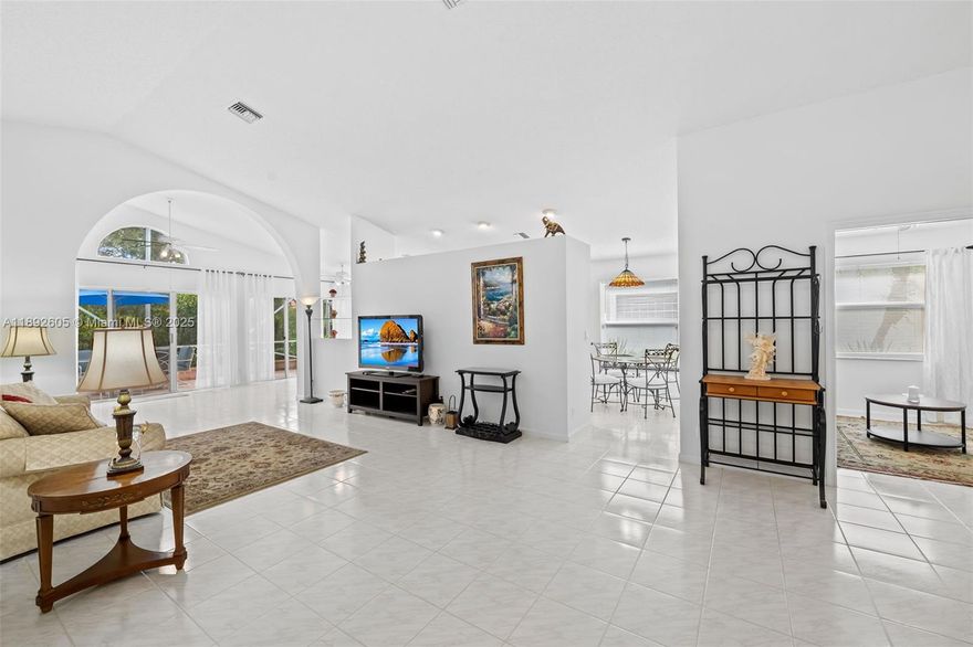 Welcome to Palm Isles, a vibrant 55+ community! This beautifully maintained 3BR/2BA home with a large office/den features a 2-car garage, stainless steel appliances, LG dishwasher, double-door refrigerator, and newer A/C & water heater (2023). Enjoy cable, Wi-Fi, and ADT alarm included. The eat-in kitchen offers granite countertops, white tile floors, and ceiling fans in every room. Master and guest rooms have clean beige carpet and ample closets. Relax on the spacious expanded patio—tiled, furnished, screened, and fully covered. Palm Isles offers a 50,000 sq.ft. clubhouse with indoor/outdoor pools, fitness center, café, theater, card rooms, plus tennis & pickleball courts.