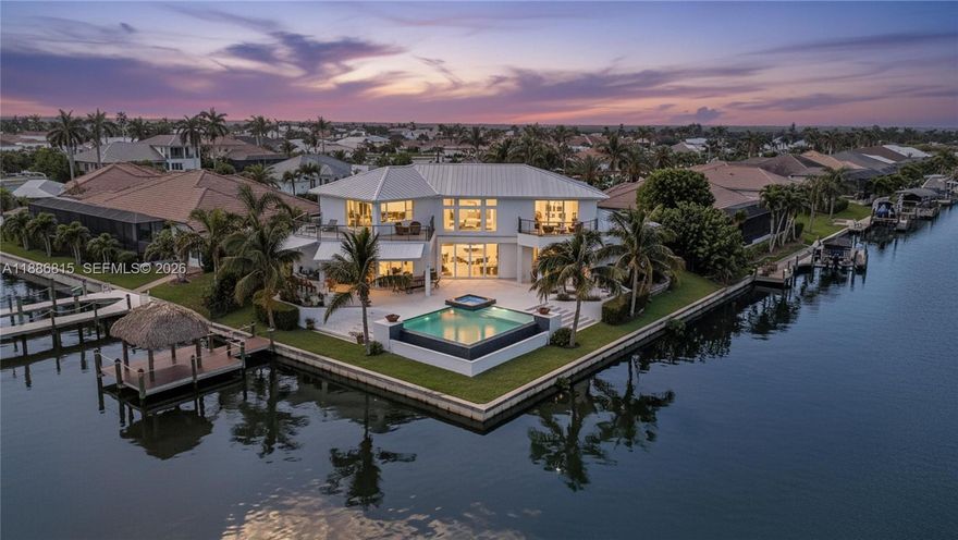 2018 waterfront custom-built luxury estate in SW Cape Coral, ideally positioned at a private cul-de-sac with 192 ft Gulf-access waterfrontage and stunning canal views. This modern home boasts 4 Beds + an office, 4.5 Baths, modern finishes, and Savant smart home tech. It features impact windows, abundant natural light, and serene water views. The gourmet kitchen includes Wolf and Sub-Zero appliances, quartz countertops, a bar, and a butler's pantry. The first-floor oversized primary suite offers a boutique closet and a spa-like bathroom. Upstairs, find a loft, a second primary bedroom, and two additional en-suite bedrooms with private balconies. Outdoors, enjoy the infinity-heated pool, 2024 tiki hut, summer kitchen, and fenced patio. A rare Gulf-access gem! Schedule a showing today!
