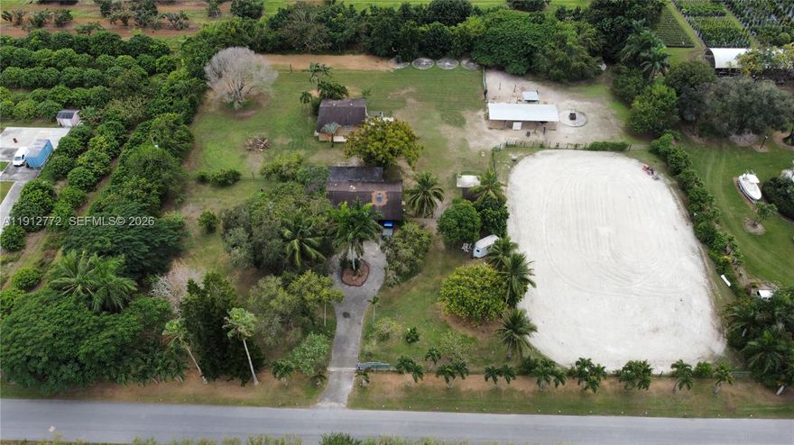 Gorgeous Homestead property! Country cottage, mini farm that features laminate and tile floors, fan/lights, brick wood-burning fireplace; beautiful kitchen with dark wood cabinets, granite counters, stove, new fridge, dishwasher, and fresh paint throughout. Master bedroom with sliding door to Florida room, closet & shower. Two additional bedrooms with closets. Laundry room with washer and dryer w/window and door to carport. Large Florida room with polished cement floor. Large riding ring, 4-stall metal pole barn, detached 31x30 CBS shop with a 9'1/2"x5'4" addition with sink, toilet, shower drain. Lush tropical fruit trees, and park-like grounds. No HOA, no deed restrictions, multiple business opportunities. New underground electric being installed. PROOF OF FUNDS AND/OR PRE-APPROVAL LETTER REQUIRED PRIOR TO SCHEDULING A SHOWING OF THE PROPERTY!