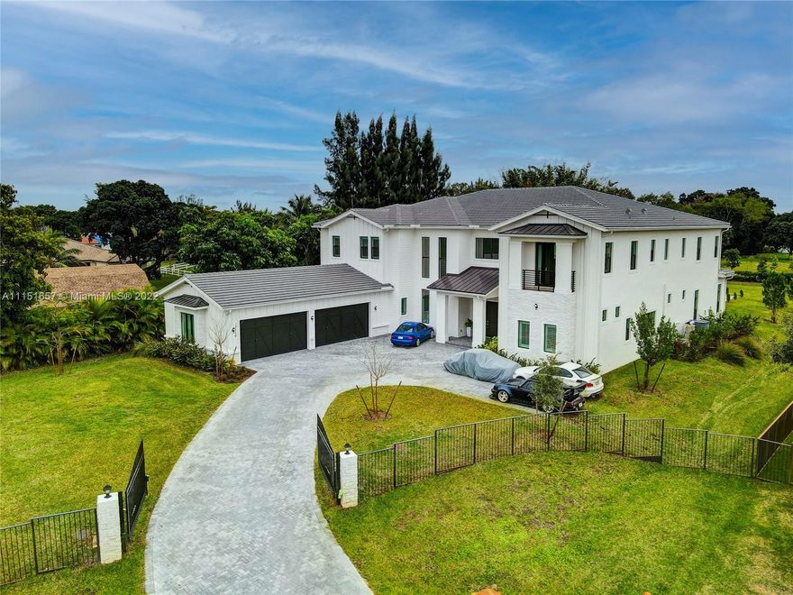 9,075 SQFT including the 4-car garage! RECENTLY BUILT IN 2021 2-story one-of-a-kind out of 8 Homes Estates at the Reserve in Southwest Ranches. Features a foyer that leads to a formal living area with a fireplace and large impact windows which allows plenty of natural light throughout the home. A formal dining area. Large kitchen with Wolf ovens and Sub-Zero refrigerator/freezer. Ample cooking island overlooking the spacious family area. A Gym designated room. Master bedroom on the first floor with a sitting area. Master bathroom en-suite with tub and walk-in shower. The second floor features wooden flooring, a spacious den, a theater room, and 4 bedrooms.  The exterior back features a large pool and expansive yard!