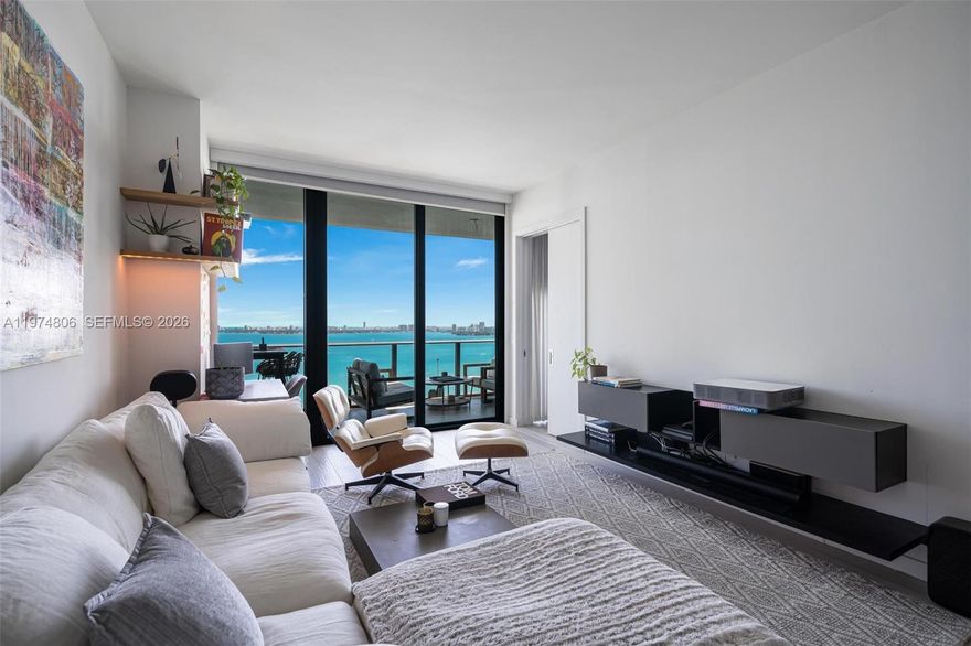 Perched on the 23rd floor of Gran Paraiso, this oversized 1-bedroom, 2-bathroom residence seamlessly blends high-floor elegance with smart-home sophistication. Accessed via a private elevator entry, the home opens into a meticulously curated space featuring custom designer wallpaper, a hotel-inspired foyer, and bespoke cabinetry accented by integrated LED lighting and waterfall countertops. Beyond the 8-foot-deep terrace offering panoramic bay and ocean views, the interior boasts premium upgrades including a wine cellar, electric blinds, and a fully integrated tech suite featuring Sonos, Philips Hue, and Nest systems. Complemented by a rare LOBBY LEVEL parking spot and world-class amenities—from a bowling alley to tennis courts, spa, pool with towel service, gold simulator, cinema room to cite a few —this residence offers an unmatched lifestyle just steps from the Design District and minutes from Miami Beach.