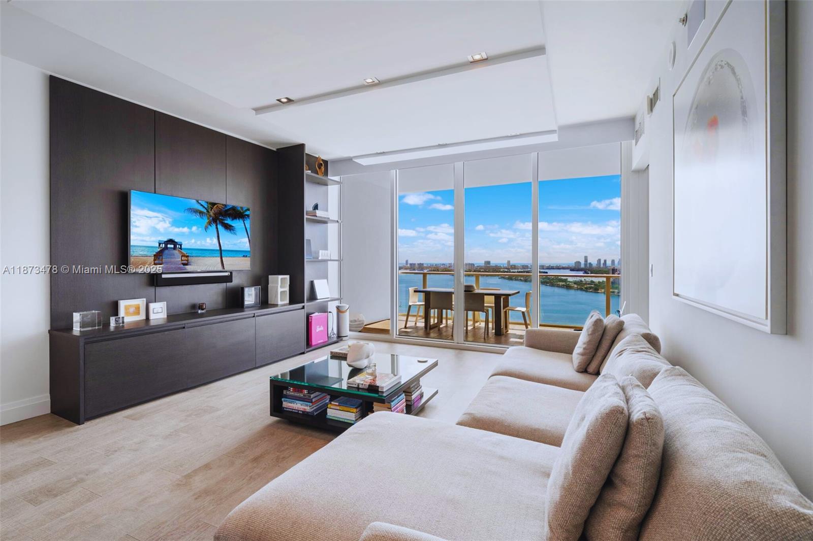Enjoy direct bayfront & dramatic city views from this sophisticated, flow-thru 2-bdrm/2.5-bath + den home that blends elegance, function & artful design. Spanning nearly 1,700 SF, the beautifully appointed interiors feature Porcelanosa wood floors, custom European doors, Italian cabinetry & Wolf/Sub-Zero appliances. The spacious den offers versatility; large walk-in closets & full laundry rm provide ample storage; integrated Savant/Sonos smart technology ensures modern convenience. Paramount Bay by Arquitectonica w/ interiors by Lenny Kravitz, is celebrated for resort-style amenities, including sunrise & sunset pools, spa & fitness center, club lounge, theater & 24/7 concierge. Edgewater’s premier bayfront address offers effortless access to Midtown, Wynwood, Design District & Miami Beach.