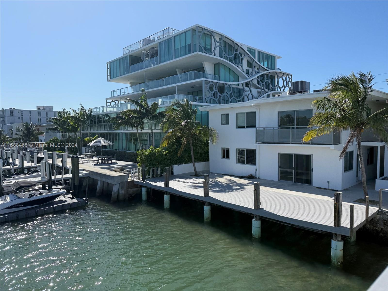 WATERFRONT BUILDING ! Access waterfront/deck  from your living area. This beautiful bottom corner unit 2 bedrooms and 2 full bathrooms. Washer and dryer inside the unit and IMPACT WINDOWS & CENTRAL A/C & HEATING. Tastefully remodeled, marble floors and a gourmet kitchen that offers granite countertops & SS appliaces. Recently painted! New closet doors being installed. Convenient first floor unit. Relax in the bay front deck area with breathtaking bay views from your living area.  Amazing location and a short walk to the beach/park. Very private building with only 6 units . Brand new deck -common area. Assigned parking available for an additional $100 fee. Boat dock spaces available for rent.
