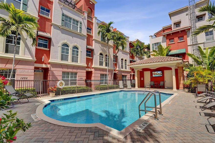 Magnificent 4-level Mediterranean-style townhouse with a large and private rooftop terrace in one of East Fort Lauderdale's most sought-after gated communities. This southwest corner unit has lots of natural light pouring in from two directions, high ceilings, crown molding, and this unit walks out to the pool. 3 bedrooms, 3.5 baths, two-car attached garage, in unit laundry room — plus every bedroom has its own ensuite... primary suite has roman tub and separate shower. Wood and tile floors throughout, granite countertops, hurricane impact windows, fresh paint, and in-unit laundry. Clean, updated, and move-in ready! Only 1.5 miles to Fort Lauderdale Beach, and Las Olas. Trader Joe's, Whole Foods, The Fresh Market, and Nordstrom all walkable. Holiday Park right around the corner, with endless dining, shopping, and entertainment in every direction. New roof 2024.
The rooftop terrace overlooks the pool with downtown Fort Lauderdale views in the distance — day or night, it's a scene that doesn't get old. This is a well-positioned unit in a well-run community, and the location simply can't be beat.