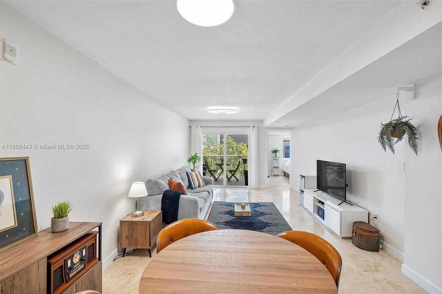 Welcome to this beautifully maintained 1 bed / 1.5 bath condo in the boutique Marquis I of Coral Way. This bright, open-concept 779 sq. ft. home features restored travertine floors, fresh interior paint, and new LED smart lighting throughout. The kitchen has refaced cabinets, open shelving, a new backsplash, updated faucet, and a tankless water heater. The main bath offers a new vanity, faucet, toilet, and reglazed tub. Enjoy added closet storage, a 2022 A/C, and Bosch washer (2021). Building includes covered parking, gated entry, gym, and security cameras. Centrally located near Brickell, Coconut Grove, and Coral Gables in a calm, well-managed community.