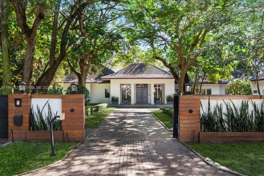 Set behind lush landscaping on approximately 1.1 acres in South Coconut Grove, this expansive one-story residence delivers 11,766 total SF with 6 bedrooms, 7 full bathrooms, and a powder room. Designed for comfort and effortless entertaining, the home showcases 12-foot ceilings, wide-plank wood floors, impact French doors, and refined architectural detailing throughout. Multiple living areas include formal and casual spaces, a wet bar, staff quarters, and a showpiece kitchen outfitted with custom cabinetry, quartz surfaces, a walk-in pantry, and a full set of premium Wolf, Sub-Zero, and Miele appliances. Two generous primary suites feature private sitting area, office, spa-style marble baths, and custom walk-in closets. The outdoor setting feels like a private resort, offering covered terraces, a heated pool, a separate oversized spa, half basketball court, volleyball court, outdoor entertaining areas, and a detached guest house currently configured as a gym. Additional features include a 4-car garage, whole-home generator, advanced smart home and security systems, and expansive grounds ideal for refined Grove living.