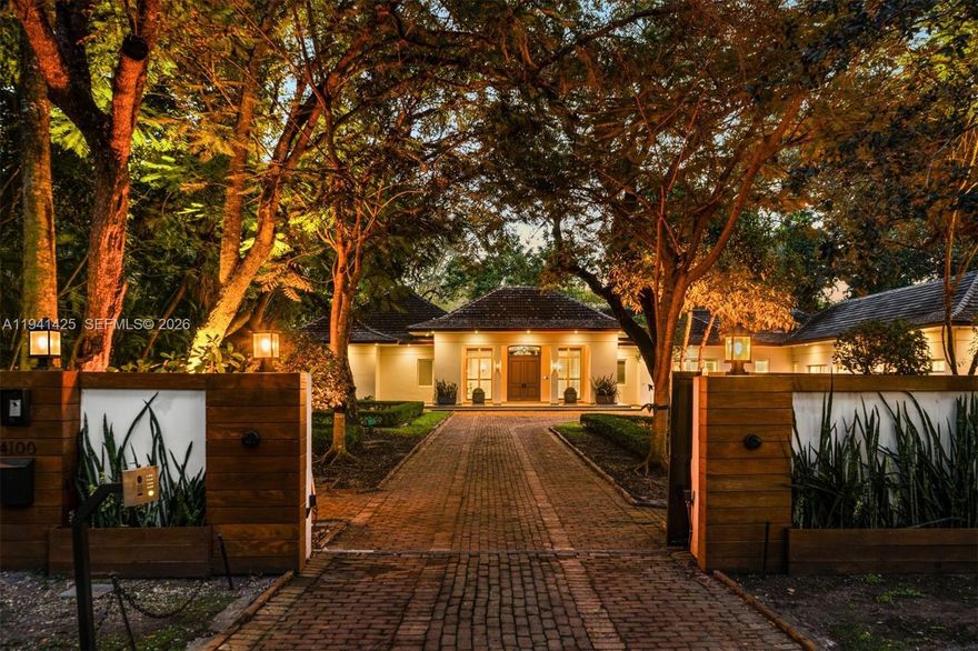 Set behind lush landscaping on approximately 1.1 acres in South Coconut Grove, this expansive one-story residence delivers 11,766 total SF with 6 bedrooms, 7 full bathrooms, and a powder room. Designed for comfort and effortless entertaining, the home showcases 12-foot ceilings, wide-plank wood floors, impact French doors, and refined architectural detailing throughout. Multiple living areas include formal and casual spaces, a wet bar, staff quarters, and a showpiece kitchen outfitted with custom cabinetry, quartz surfaces, a walk-in pantry, and a full set of premium Wolf, Sub-Zero, and Miele appliances. Two generous primary suites feature private sitting area, office, spa-style marble baths, and custom walk-in closets. The outdoor setting feels like a private resort, offering covered terraces, a heated pool, a separate oversized spa, half basketball court, volleyball court, outdoor entertaining areas, and a detached guest house currently configured as a gym. Additional features include a 4-car garage, whole-home generator, advanced smart home and security systems, and expansive grounds ideal for refined Grove living.