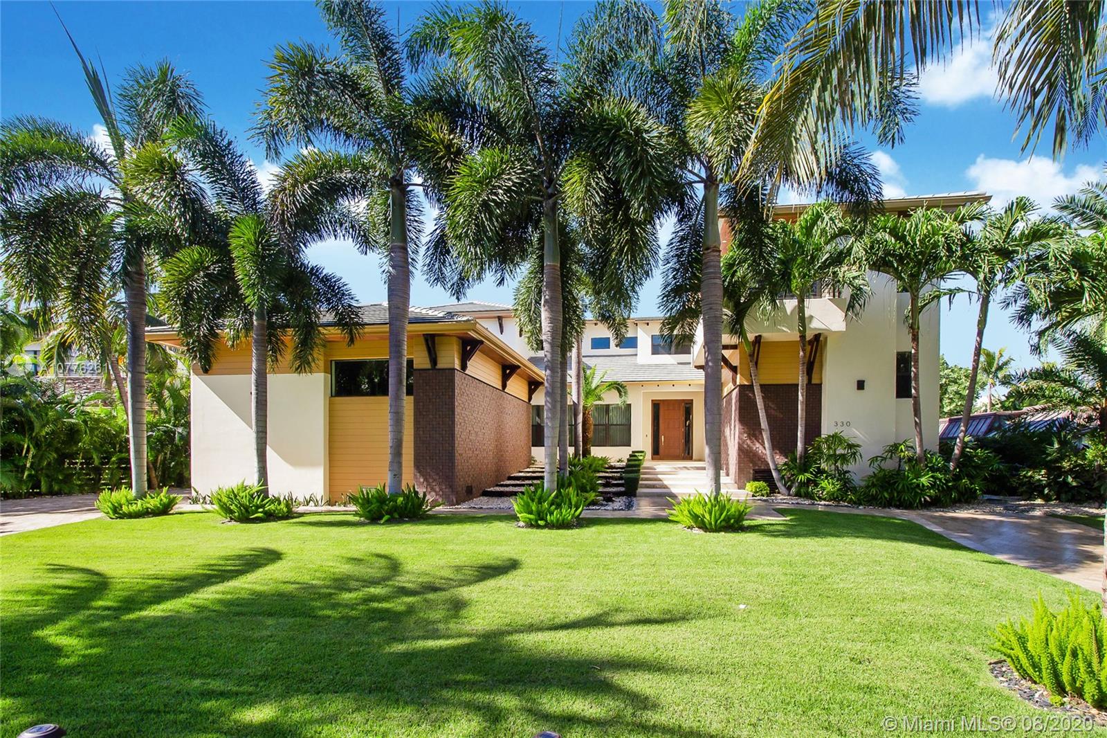 Contemporary home built on an oversized lot. The entire house has been finished & detailed with the highest quality materials, doors and woodwork! The first floor features an open concept kitchen, family room and breakfast area. Off the kitchen area is an enclosed, 2 car garage, with a high ceiling/workshop and cabinet storage. The first floor provides 3 bedroom suites, each with a private bath, separate cabana/guest bath, formal living and dining rooms. The second floor offers a work area, plus 2 additional guest suites, with private bath. The master bedroom suite has his & her, walk-in closets, & a spa-like bathroom. The house is surrounded by a manicured garden with royal palms, shrubs, flowers & pathways! The spa/pool is attached to a large, covered terrace, perfect for entertaining.