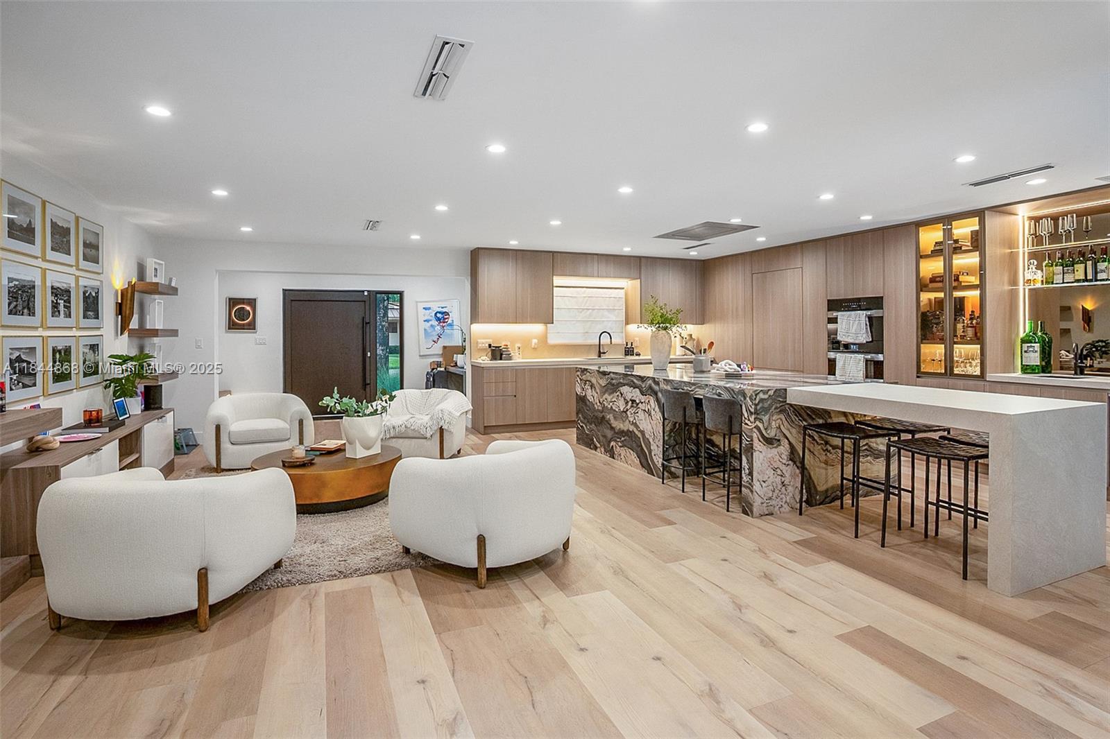 Experience luxury living in this fully renovated and expanded 2023 Pinecrest home. Gutted and reimagined with modern design and high-end finishes, this turnkey gem features a chef’s kitchen with Miele appliances, hidden walk-in pantry, and built-in bar. The spa-inspired primary suite offers a private lounge, hidden office, and luxe bath. Two oversized en-suite bedrooms downstairs, plus two additional bedrooms, one used as a gym with sauna. Indoor laundry, heated pool, and sleek outdoor kitchen. New roof, impact windows, updated plumbing, HVAC, and designer details throughout. A rare Pinecrest find for buyers wanting a new construction feel without the wait.