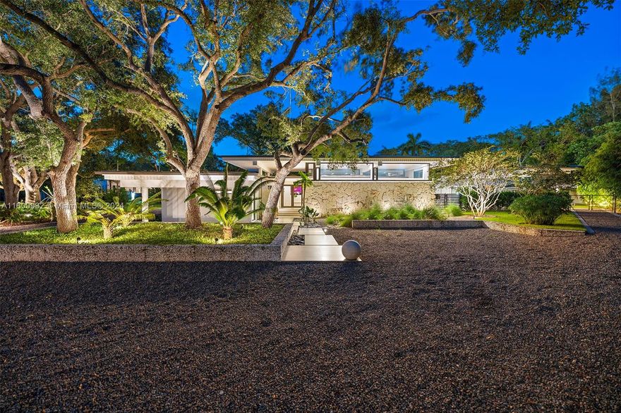 A residence like no other! Exquisitely designed and meticulously reimagined, this 9,000+ sqft Mid-Century Modern masterpiece sits on one of Pinecrest's best streets. Fully renovated, it seamlessly blends indoor/outdoor living with walls of impact glass overlooking pristine gardens on a .9 acre lot. Perfect for entertaining, it features a flexible open-concept layout, new Italian-style kitchen with JennAir appliances, a beautiful grilling terrace, sparkling pool, and fire pit. The main residence offers 5 bedrooms and the detached guest cottage is 830+ sqft. Additional highlights include a 1,000+ sqft air-conditioned garage, 2021 roof, new HVAC, artificial turf, and smart home features. Conveniently located in flood zone X near top schools and parks. Click virtual tour for video!