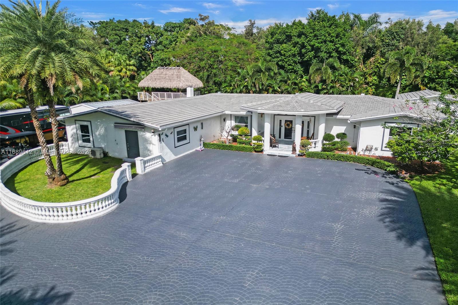 Escape to your own private oasis within an electric-gated compound on a sprawling one-acre lot. This rare property features a 4-bedroom, 3-bathroom home, with the option for a 5th bedroom, den, office or media room. The property also includes a 2-car insulated garage with air conditioning and a brand new roof. Step inside the main home to discover a perfect blend of modern elegance and functionality. The spacious layout boasts a large family room with a charming wood burning keystone fireplace, a formal living room, and an over sized dining area—perfect for both everyday living and entertaining.