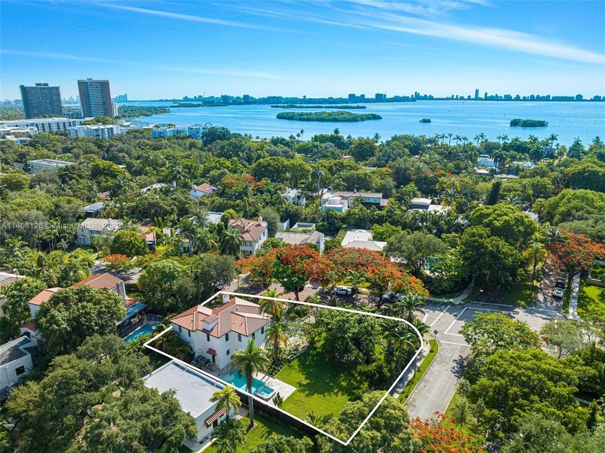 Available for the first time, this historic gated Morningside gem has been restored to its original 1920s beauty with all new electrical, plumbing, A/C, roof and impact windows. The property boasts an oversized 15,000 sqft corner double lot with a large newly installed salt water pool and hot tub with a natural waterfall adjacent to an expansive lush green yard blocks from Biscayne Bay. Ground floor has a massive chef’s kitchen with 2 separate sinks, high end fixtures and appliances next to a very large laundry room with deep sink basin. The entrance foyer and Florida room are lined with majestic windows, providing plentiful natural light to a grand room with a restored original working fireplace. Genuine crystal chandeliers illuminate throughout paying homage to the grandeur of the 1920s.