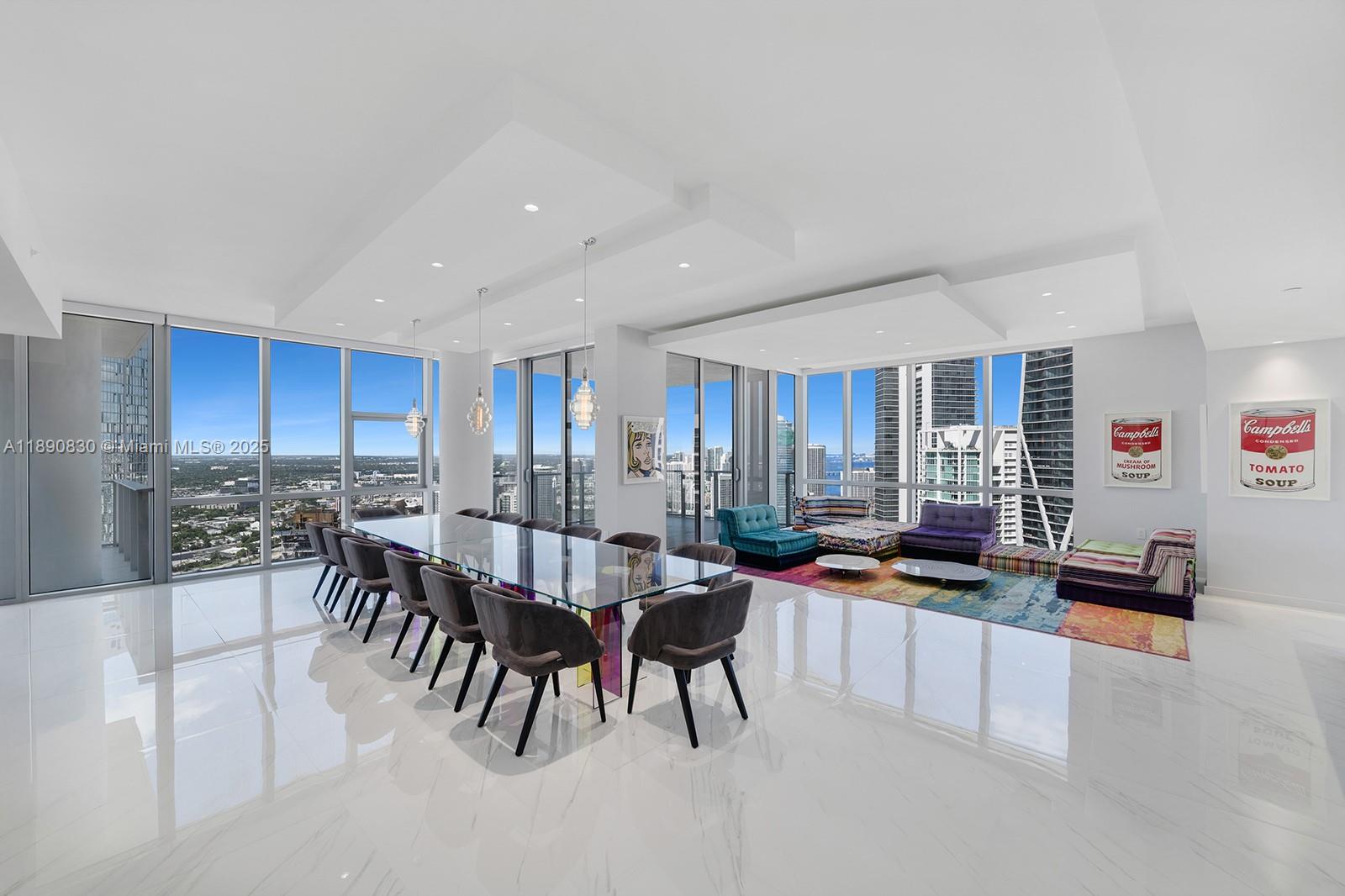 Paramount Miami, home to Miami’s largest amenity collection, presents its only combined residence: a one of a kind 4 bed 5 bath + den corner home over 4,500 SF. Near new and custom throughout, wrapped in glass with 3 balconies for skyline and bay views. Expansive great room, two separate family rooms and formal dining for large gatherings. The towers largest custom kitchen with premium appliances, double ovens, wine storage and oversized island. Grand primary suite with living area, dual walk-in closets, and luxurious bath. 10-foot ceilings, laundry room, 2 private elevator foyers. Furnishings by French design house Roche Bobois. Two side by side assigned spaces near the elevator plus valet; option to buy a third. Adjacent 2 bed 3 bath for sale next door (#4403) for guest quarters/office.