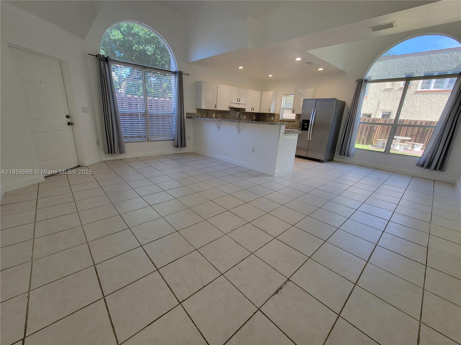 Living space is open and bright with vaulted ceilings and large windows with lots of natural sunlight. Freshly painted, immaculate condition. Private gated entry and fully fenced in yard to enjoy, large driveway with space for up to 4 cars. Features modern kitchen with granite counter tops and backsplash, tile throughout, a large walk in master closet, laundry room with washer and dryer, 100% LED lighting, efficient central AC. Landscaping is included. Has hurricane panels so you can be protected in case of a storm. This property is generally nicer and newer than others in the neighborhood.