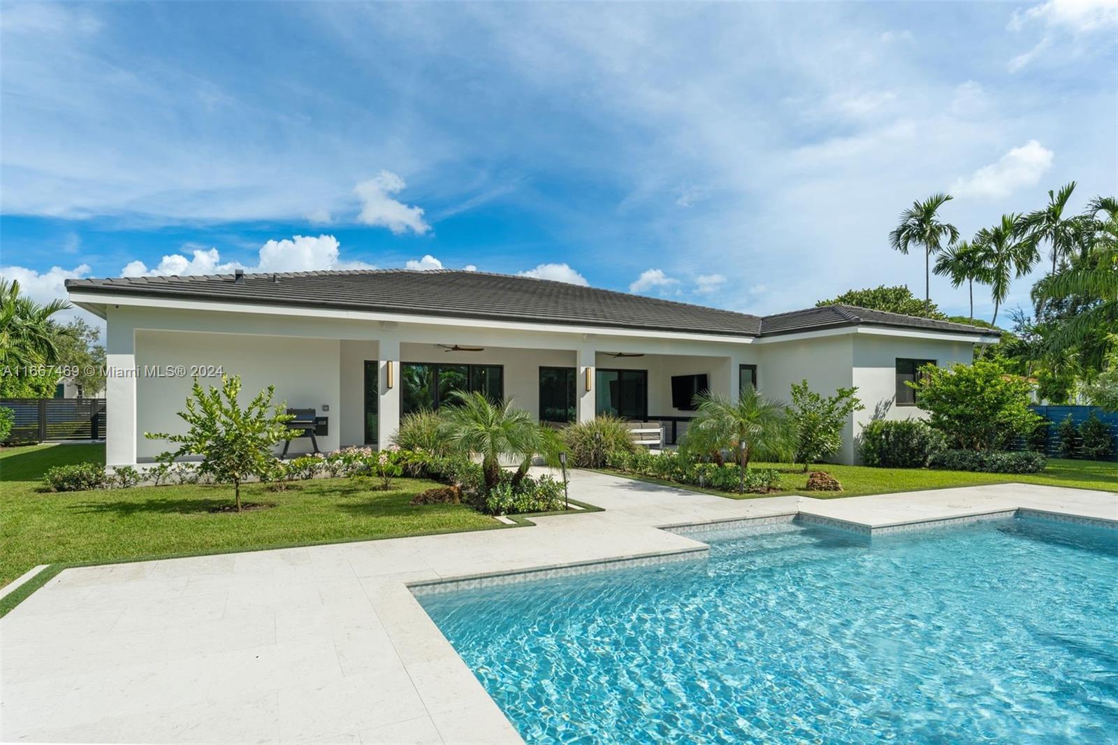 Fully gated and beautifully designed modern residence recently completed in 2023, with 5 BD and 5.5 BA on a spacious, tranquil lot, with open and airy living, family and dining areas and a versatile bonus room. The bedrooms have en-suite bathrooms and walk-in closets, and the chef’s kitchen features appliances by Fulgor Milano and Miele and floor-to-ceiling custom cabinetry by Veneta Italian Cucine. Large sliding doors showcase views of the lush, private back yard and covered terrace with fans and sparkling pool. Features include Sonos speakers and Wifi controlled lighting and sprinkler systems. Concerns about storms are reduced by high-grade impact windows and doors, 48k W generator and natural gas connection. The two-car garage is temperature-controlled and has an EV car charging outlet.