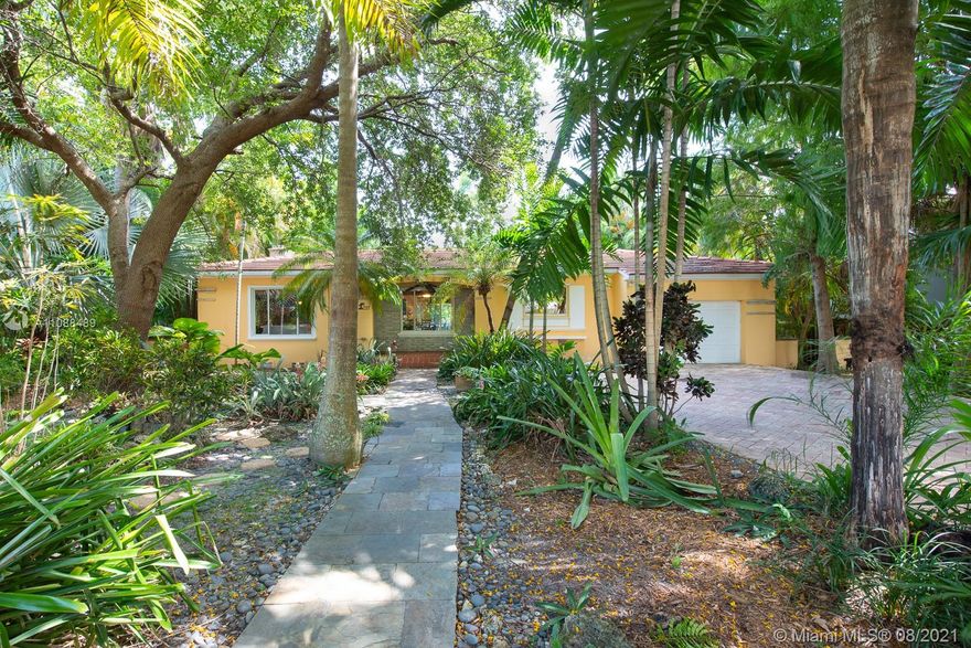 Beautiful, tropical pool home in the heart of Miami Shores.  Built in 1946 for the community developer, this 3 bedroom, 3 bathroom, 1 car garage home features a fully renovated kitchen, and all the charm you'd expect from a cottage home. Covered porch, fireplace, built-ins, granite counters, ss appliances, finished garage (an easy conversion to a 4th bedroom), enclosed recreation room with bar and wood ceiling overlooking the pool area, large bedrooms with cedar closets, and 2 vintage bathrooms, tons of natural light, and tile flooring throughout are just some of the features that make this home unique.  Amazing location east of US1, tropical mature landscaping in front and back, and large pool make this an entertainer's dream. Close to shopping, restaurants, and world class beaches!