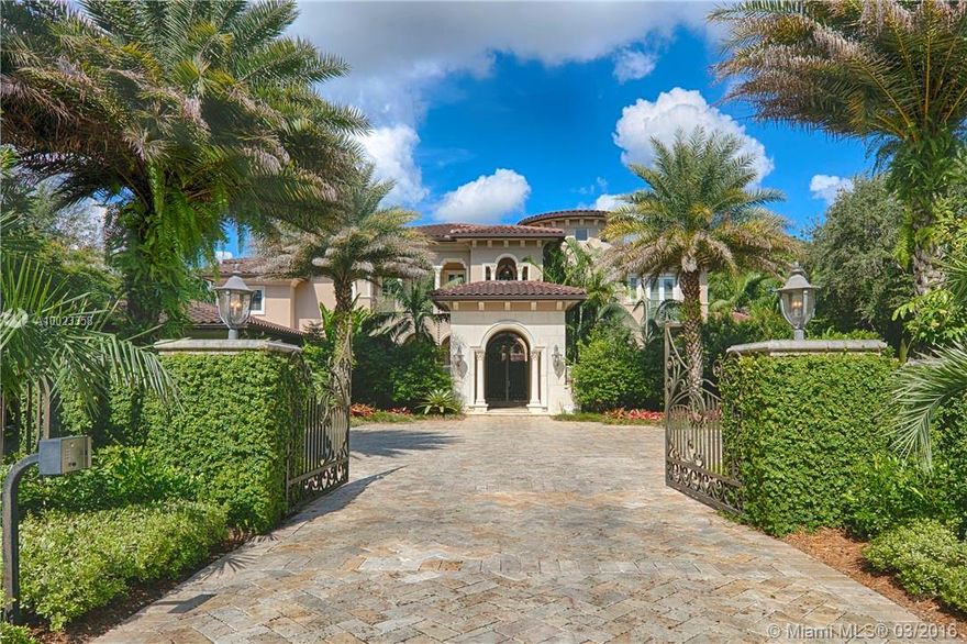 Situated on over an acre is a gated Pinecrest estate with stunning designer finishes. This home features a grand foyer, formal living & dining rooms, & a chef's eat-in kitchen which opens to a bar area w/wine cellar & family room.The master suite includes his & her walk-in closets, spa-like bath, & French doors leading to the gorgeous back yard. Entertain family and friends on the covered patio, summer kitchen, lagoon-like pool with Jacuzzi all overlooking the beautiful landscaping. 3 car gar. Generator.