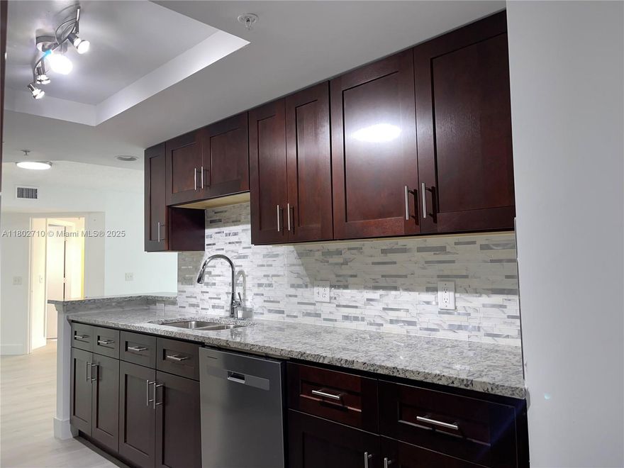 Fully remodeled Move in Ready! Spacious and unique 3-bedrooms, 2-bathrooms with a car garage. Brand new all SS appliances, wood cabinets with granite counter top, porcelain flooring, full size washer/dryer, A/C is just a year old. fire sprinkler system-an opportunity that doesn't come around often! Located in a secure, gated community offering a range of amenities including a resort style pool, clubhouse with fitness center, tennis, a car wash area and more. Centrally located near Palm Beach Outlets, downtown, I-95, and the Turnpike. One minute away from Lincoln park with full of fun. Don't miss out--schedule your visit today!