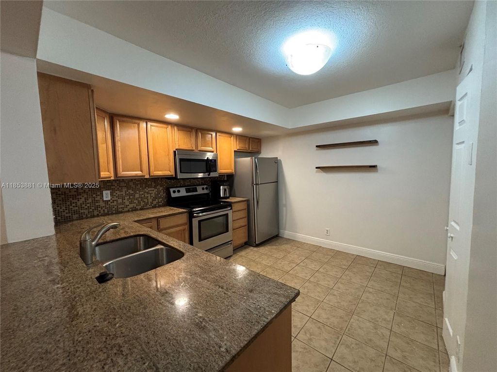 Photo of 5761 Riverside Dr #105B4, Coral Springs, FL 33067 (MLS # A11853881)