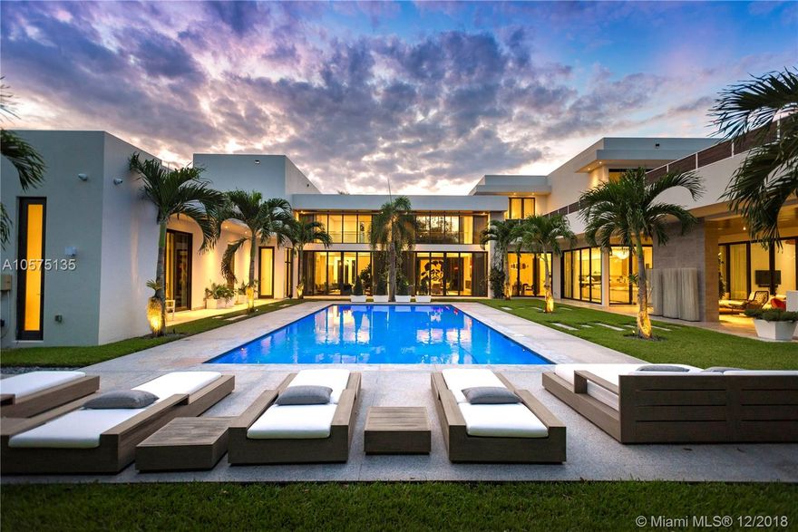 Designed with the art collector in mind, this unique two-story modern estate spans a generous 9,855 sqft and includes 9 Bedrooms and 9.5 Bathrooms. Laid out to easily communicate with the spacious Guest house/In-law suite, summer kitchen and outdoor entertainment area. Ideal for a family or a multi-generational family. Master suite boasts over-sized his/her closets and private sundeck. Outfitted with state-of-the-art smart-home technology with 20 security cameras, 24-foot ceilings, floor-to-ceiling impact windows, stainless steel state-of-the-art Wolf and Sub-Zero appliances, marble/wood flooring throughout, 7 seat home theater, 432 bottle wine cooler, private elevator, 150KW generator and a heated infinity edge pool sitting on an impeccably landscaped 37,897 sqft lot.