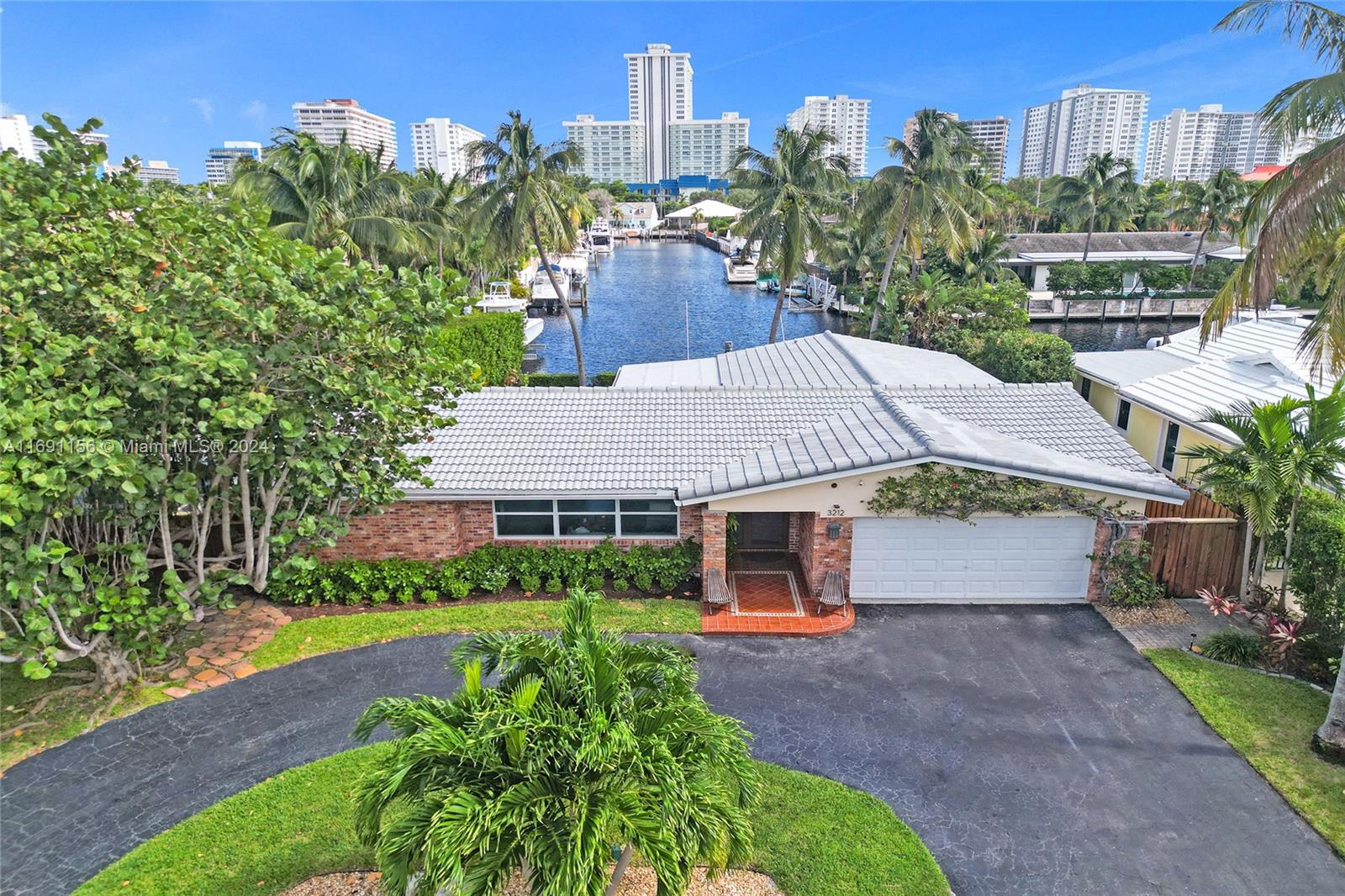 Spectacular Ocean Access Home offers Tranquil Water & Pool Views. Meticulously maintained and Boasts a Brand New Roof and Impact Windows. Situated on a Waterfront Point Lot with 65' Deep Water Frontage and No Fixed Bridges. Private Dock. Enjoy a Fabulous Year-round Ocean Breeze coming from the East. Resort Style Yard that features a Saltwater Pool, a Jacuzzi and Large Covered Patio. Built in Gas Grill. Great House for Entertaining. Inside you will find a Beautifully Remodeled kitchen that is a chef's dream. Top of the line appliances and Custom Cabinetry with Quartzite Countertops. Open Floor Plan with Views from almost every room. Cabana Bath. Recessed Lighting throughout. Amazing Location. Walking distance to the Beach, Restaurants , Shops and Nightlife. A True Must See!