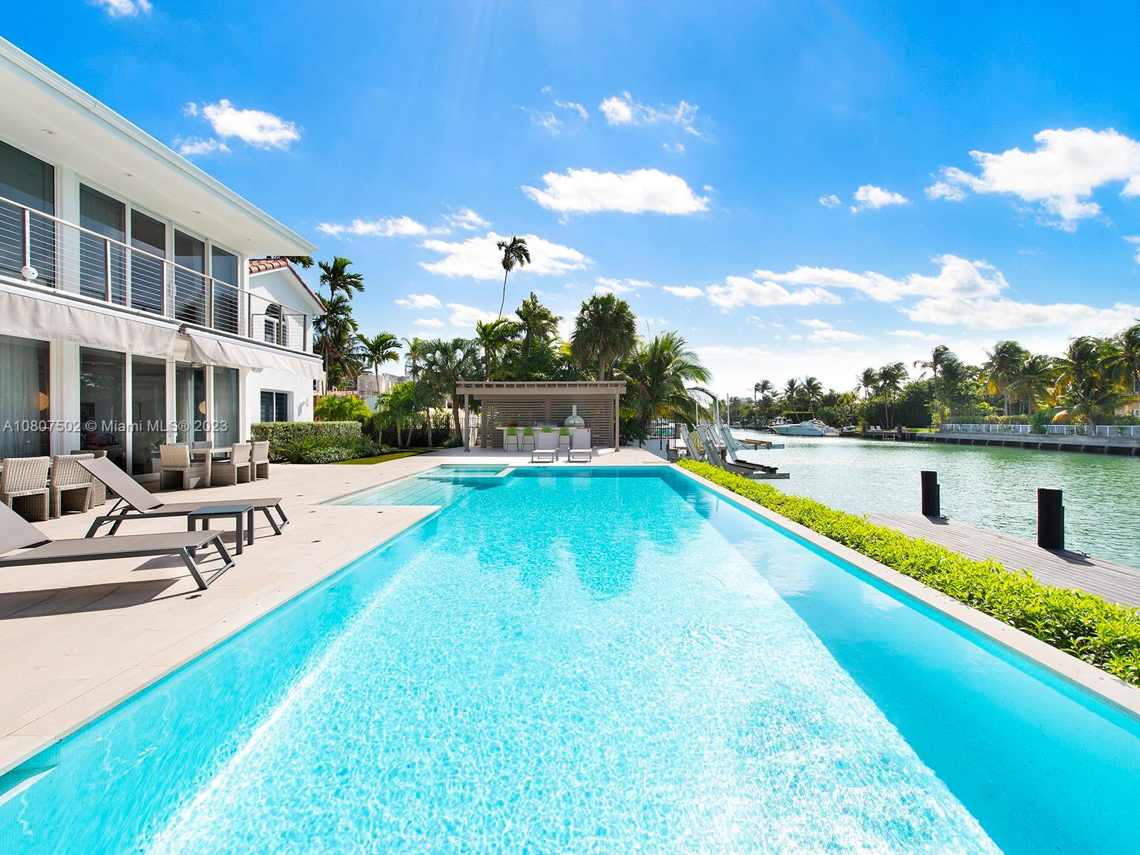 Recognized as a rare jewel in Miami Beach, this two-story historic estate sits on a 24,064 SF double lot with 128 ft of waterfront. Featuring 7 Bed / 5.3 Bath, you will revel in an Italian inspired gourmet kitchen, spacious dining and living room spaces, fine quartz and resin conglomerates flooring throughout the ground floor, custom-made aluminum and wood suspended stairs, a fully equipped Life Fitness gym and spa, and much more! Amenities include floor-to-ceiling impact glass doors and windows, a private elevator with wheelchair access, 46 x 23 ft ground pool with chromotherapy lighting and jacuzzi, 120 ft long deck, and two large boat. Lushly landscaped grounds provide the utmost in beauty and privacy.