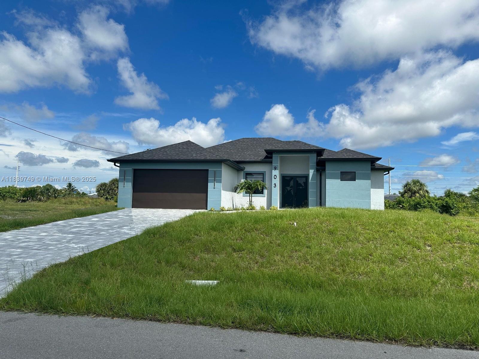 Why wait for new construction when this modern waterfront home is ready today? Built in 2025 and never lived in, this canal-front property offers 3 bedrooms + den, 3 full baths, wide paver driveway, soaring ceilings, 8ft+ doors, 32x32 porcelain tile, and impact windows/doors. Chef’s kitchen with quartz waterfall counters, custom soft-close cabinetry, stainless appliances, and black fixtures. Owner’s suite has walk-in closet, dual vanities, and frameless shower. Den can serve as office or 4th bedroom. Covered lanai overlooks canal. 2-car epoxy garage, indoor laundry, water treatment, city water/sewer scheduled soon (private well now). Flood Zone X—no insurance required. No HOA, no rental restrictions. Vacant, move-in ready, seller offering closing cost help. CO issued 08/12/25.