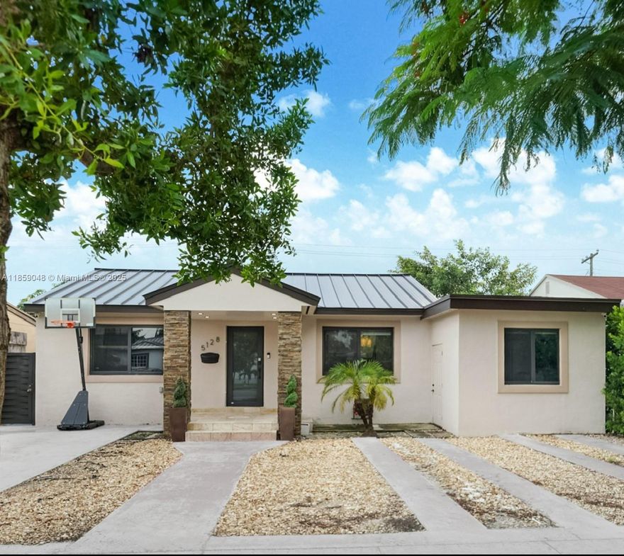 Beautifully updated 4BR/3BA Miami home just 20 mins from the airport, Downtown, and Miami Beach! Includes a second kitchen – perfect for in-laws, extended family, or short-term rental income. Features a modern kitchen with quartz countertops, waterfall island, stainless steel appliances, and designer lighting. Open living space with LED accents and stone feature wall. Private laundry room with Samsung washer/dryer. Outdoor area includes a covered patio, lounge space, and fenced yard ideal for entertaining. Separate entrance on the right side offers excellent Airbnb potential.