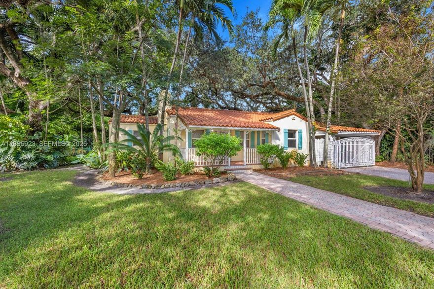 Escape to timeless Coral Gables charm surrounded by majestic oak trees & lush tropical gardens. This beautifully updated 3 bedroom, 2 bathroom home sits on an expansive 9,844 sqft lot with ample space to expand, add a pool, & create an ideal outdoor entertaining area. Featuring a 2019 Spanish tile roof, impact windows & doors, & a gated carport, this residence blends classic elegance with modern upgrades. Inside, a warm & inviting living room with wood floors & a cozy fireplace flows seamlessly into a designer kitchen with high ceilings, porcelain floors, & top quality appliances. The spacious bedrooms & elegantly renovated bathrooms showcase floor to ceiling marble finishes. Located near the Granada Golf Course, Coral Gables Country Club, & the vibrant shops & restaurants of Miracle Mile.