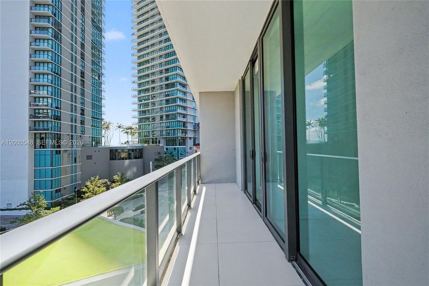 Luxurious 1-bedroom, 1.5-bath residence in Paraiso Bayviews with high ceilings and white tile flooring throughout, including the balcony. Bright unit featuring a spacious living area, open Italian kitchen with Bosch appliances and cooking island, and walk-in closet. Primary bath with double sink vanity and modern shower. Custom shades, washer/dryer in unit, and garden views.

Full-service building with rooftop pool (46th floor), second pool, spa, sauna, gym, kids room, social lounge, valet, and on-site management. One assigned parking space.
