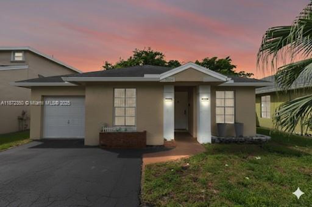 Photo of 5904 Woodland Point Pl, Tamarac, FL 33319 (MLS # A11872350)