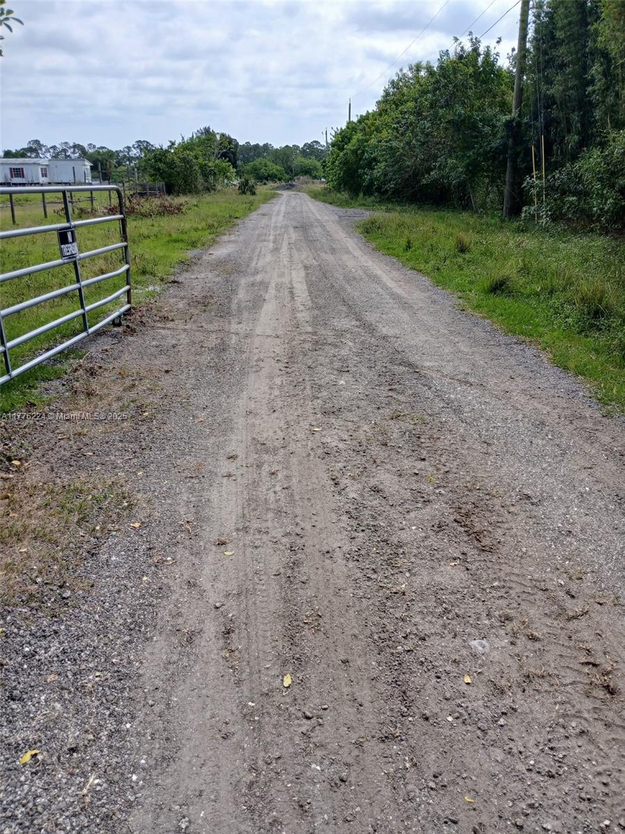 This Ranch sits on 5.04 acres, fully fenced, cleared and ready for your vision! This property features a double wide trailer, electric in place, and a brand-new artesian well capable of filling the large 6-9 ft deep pond. Perfect for swimming and water sports. Impact fees have already been paid, saving you time and money. Plenty of space to expand or build another house.