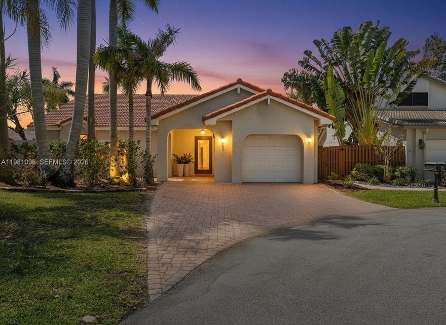 Fully reimagined one-story residence tucked away on a quiet cul-de-sac in Weston. This beautifully updated home offers 2 bed, 2 bath, and 1,325SF of bright living space with a split floor plan. The interior features vaulted ceilings, high baseboards, impact windows and doors throughout, and elegant vinyl flooring flowing throughout the home, creating a modern and airy atmosphere. The open kitchen has been fully updated with quartz countertops and a modern waterfall island, seamlessly connecting to the main living areas and creating a perfect space for everyday living and entertaining. Both bathrooms have been fully renovated with contemporary finishes. Enjoy a wonderful indoor-outdoor living experience with a spacious screened and covered patio of approximately 400SF, highlighted by a beautiful vaulted wood-beamed ceiling. The newly fenced backyard provides excellent privacy and enhances the peaceful setting of this quiet cul-de-sac lot. The front of the home features charming curb appeal with a welcoming courtyard entrance and new brick pavers. Additional features include an impact front door with WiFi keyless entry and a Ring doorbell. Ideally located in the heart of Weston near top-rated A+ schools, parks, golf courses, shopping, dining, and convenient access to major highways. Don't miss this opportunity, this one won't last long!