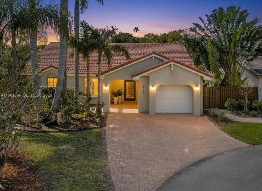 Fully reimagined one-story residence tucked away on a quiet cul-de-sac in Weston. This beautifully updated home offers 2 bed, 2 bath, and 1,325SF of bright living space with a split floor plan. The interior features vaulted ceilings, high baseboards, impact windows and doors throughout, and elegant vinyl flooring flowing throughout the home, creating a modern and airy atmosphere. The open kitchen has been fully updated with quartz countertops and a modern waterfall island, seamlessly connecting to the main living areas and creating a perfect space for everyday living and entertaining. Both bathrooms have been fully renovated with contemporary finishes. Enjoy a wonderful indoor-outdoor living experience with a spacious screened and covered patio of approximately 400SF, highlighted by a beautiful vaulted wood-beamed ceiling. The newly fenced backyard provides excellent privacy and enhances the peaceful setting of this quiet cul-de-sac lot. The front of the home features charming curb appeal with a welcoming courtyard entrance and new brick pavers. Additional features include an impact front door with WiFi keyless entry and a Ring doorbell. Ideally located in the heart of Weston near top-rated A+ schools, parks, golf courses, shopping, dining, and convenient access to major highways. Don't miss this opportunity, this one won't last long!