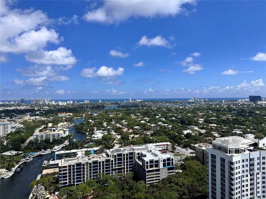 Perched on the 32nd floor of the iconic WaterGarden, this exceptional penthouse residence offers a rare combination of space, views, and sophistication in the heart of downtown Fort Lauderdale. This 2 bedroom, 2.5 bath plus Den/Office floor plan is thoughtfully designed with expansive living areas and floor-to-ceiling windows that frame breathtaking, unobstructed views of the Ocean, New River, and City Skyline. By day, enjoy endless natural light and sparkling water views and by night, take in the dramatic glow of the city below. The open concept living and dining areas flow seamlessly onto a private balcony perfect for entertaining or quiet relaxation above it all. The versatile den provides an ideal home office, media room, or potential third bedroom, catering to today’s flexible lifestyle. The desirable split bedroom floor plan with two primary suites featuring stunning water views, generous closet space, and spa inspired baths. Residents at Water Garden enjoy a full service, resort style experience including concierge service, 24 hr valet, a two-story fitness center and spa, tropical pool deck with cabanas, theater, club room, and more all just steps from Las Olas Boulevard’s premier dining, shopping, and entertainment. This is penthouse living at its finest where luxury, location, and panoramic views converge. Includes 2 Parking Spaces!