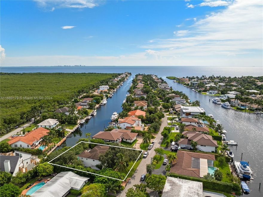 Stunning 4,467 SF two story canal-front home with 5-BD, 4.5 BA, and direct ocean access, on a 12,366 SF lot with beautifully manicured greenery, in the highly sought after guard-gated community of Gables by The Sea. The thoughtfully designed home offers a serene retreat, perfect for those seeking luxury and tranquility in a prime location. The home has an expansive open floor plan, high volume ceilings throughout, and an eat-in kitchen with sizable center island, high-end appliances, gas range, and marble countertops. Outdoor entertainment areas include a saltwater pool with jacuzzi and tanning ledge, covered terrace, pergola, and a private dock. Additional features include a large Chicago brick driveway, 2-car garage, impact windows and doors, custom built wet bar and a glass wine cellar.