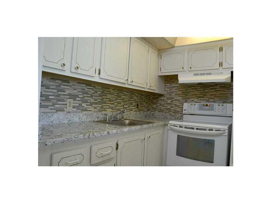 Beautiful 1 bedroom 1.5 bathroom apartment in highly desirable Century Village Community. Remodeled with wood floors, new kitchen, and more! Apartment only 10 minutes from the beach! 55+ community. Community full of amenities such as 1600-seat theatre (p roviding top name entertainers), movies, dances, 800-people party room, fitness center, billiard room, tennis courts, golf courses and much much more! Enjoy the best weather in the country at an affordable price!