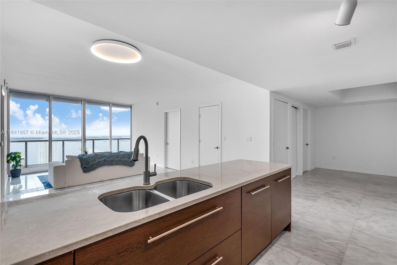 Enjoy breathtaking views of Brickell Key and Biscayne Bay from this spacious 35th-floor residence at Icon, Brickell, located next to the luxurious W Miami 5-star resort. This unit offers a split 2-bedroom + den floor plan, marble floors in the living area, wood floors in the bedrooms, and a fully equipped kitchen. The full-service building provides 24-hour concierge, valet, and security. Amenities include a massive lap pool (once the longest in the world), multiple restaurants, a movie theater, an award-winning spa, a state-of-the-art fitness center, a spinning room, lounges, a nightclub, billiards and community rooms, and more!Parking on the 5th floor-the lowest level.Experience urban living at its finest with easy access to major highways, Brickell City Centre, and public transportation.