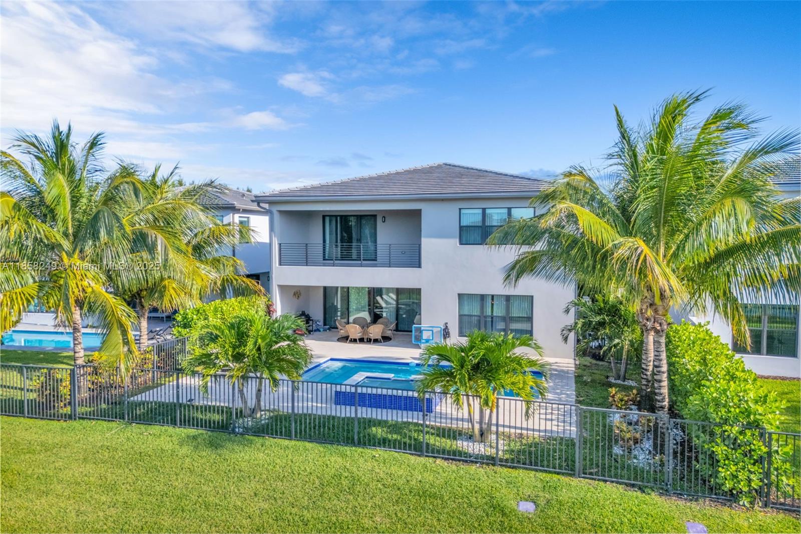 Located in Lotus, one of Boca Raton's most prestigious gated communities, this stunning 5-bedroom,5-bathroom e perfectly blends modern style with timeless luxury. Curated with a team of top designers, the home makes a dramatic first impression with a breathtaking entryway featuring intricate millwork, a lush greenery wall, and a statement chandelier. Inside, elegant and inviting spaces are designed for both comfort and entertaining- from a chef's kitchen ideal for culinary creations to sophisticated living and dining areas that make every gathering unforgettable. Additional highlights include a spacious 3-car garage, a designer style loft, and a resort-inspired backyard complete with a sparkling pool and spa. Upscale finishes and details reflects the neighborhood's sophistication.