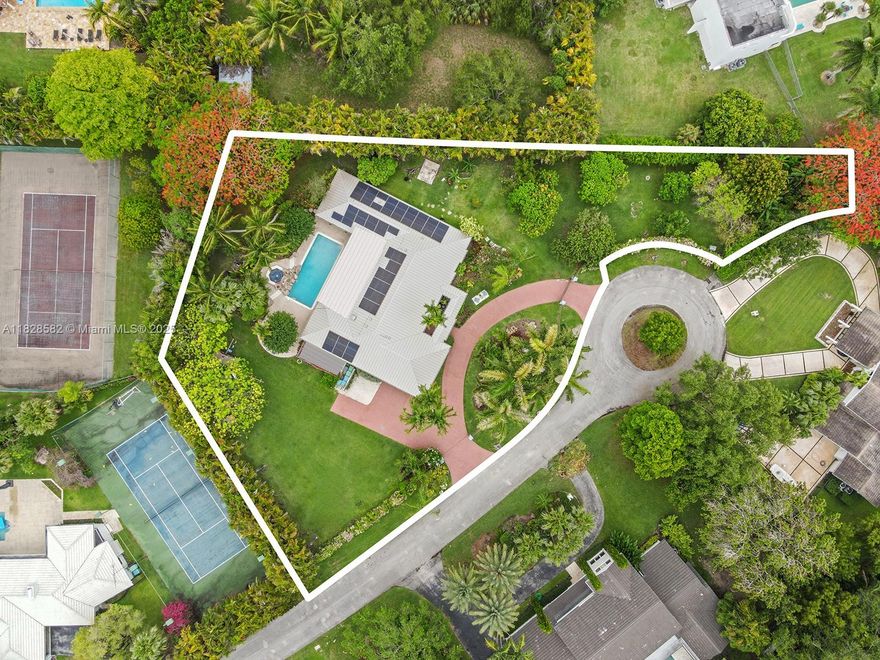 Tucked away on a quiet cul-de-sac in Pinecrest, this 4BD/4BA gated home blends comfort, elegance, and functionality. Lush tropical landscaping and an impressive variety of fruit trees—including mango, avocado, lychee, plantain, banana, starfruit and breadfruit—surround the property, creating a private oasis. The heart of the home is a custom gourmet kitchen with rich mahogany cabinetry, granite countertops, Wolf range and Thermador ovens. Spacious living areas and a full bar flow effortlessly to the outdoors, where a saltwater pool, Jacuzzi, and summer kitchen await. Additional features include custom closets, a spa-like primary suite, GarageTek garage with Tesla charger, solar power with backup battery, and a whole-house water filtration system. Perfect to live in or reimagine a true gem.