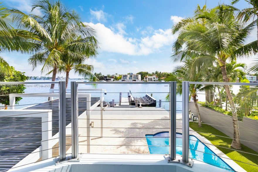 This spectacular waterfront home has been totally renovated with a construction upgrade of a new entrance and third floor railings in 2019. All the bedrooms are in suites and facing the open bay. 5 bed 5 1/2 bath with rooftop terraces. 36 x 24 CARIBBEAN BLUE marble & wood floors throughout. Beautiful kitchen with top of the line appliances, granite counter tops, impact windows, storage room, sound system, brand new back-up generator installed in 2023, new dock and a 50 linear foot seawall. New floating lift that holds up to 25, 000 lbs, and a floating dock for 2 jet ski. The Second and third floor of the house were built in 1989. With breathtaking views this beautiful property is ready for a new owner. Come enjoy the gorgeous view of the bay, and Miami.