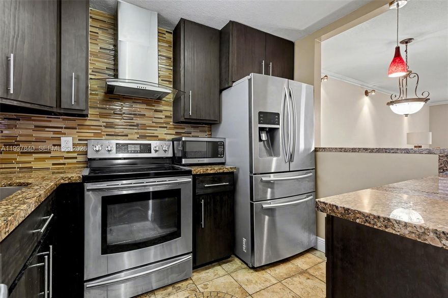 If you're tired of gray walls and white kitchens, then this is the home for you! This beauty is a 2-bedroom and 1.5-bathroom condo with warm colors throughout, espresso 42-inch wood cabinets in the kitchen with granite counters, tiled floor, and Samsung appliances. The main living area and bedrooms have espresso engineered wood flooring. Slate tile in the enclosed Florida room. The bathrooms are tiled throughout with an espresso vanity in the primary bathroom and a pedestal sink in the half bath. Crown molding throughtout the unit and no popcorn on the ceilings. Beautiful pool view from the Florida room and primary bedroom. Amenities are right outside your unit. Billard room on the same floor, shuffleboard, barbecue area are steps away, as well as the pool and clubhouse. Close to all major stores, malls, highways, and entertainment. Royal Park Gardens is a very active adult 55+ community.
**CHECK OUT 3D MATTERPORT TOUR** 40k income and 675 credit score