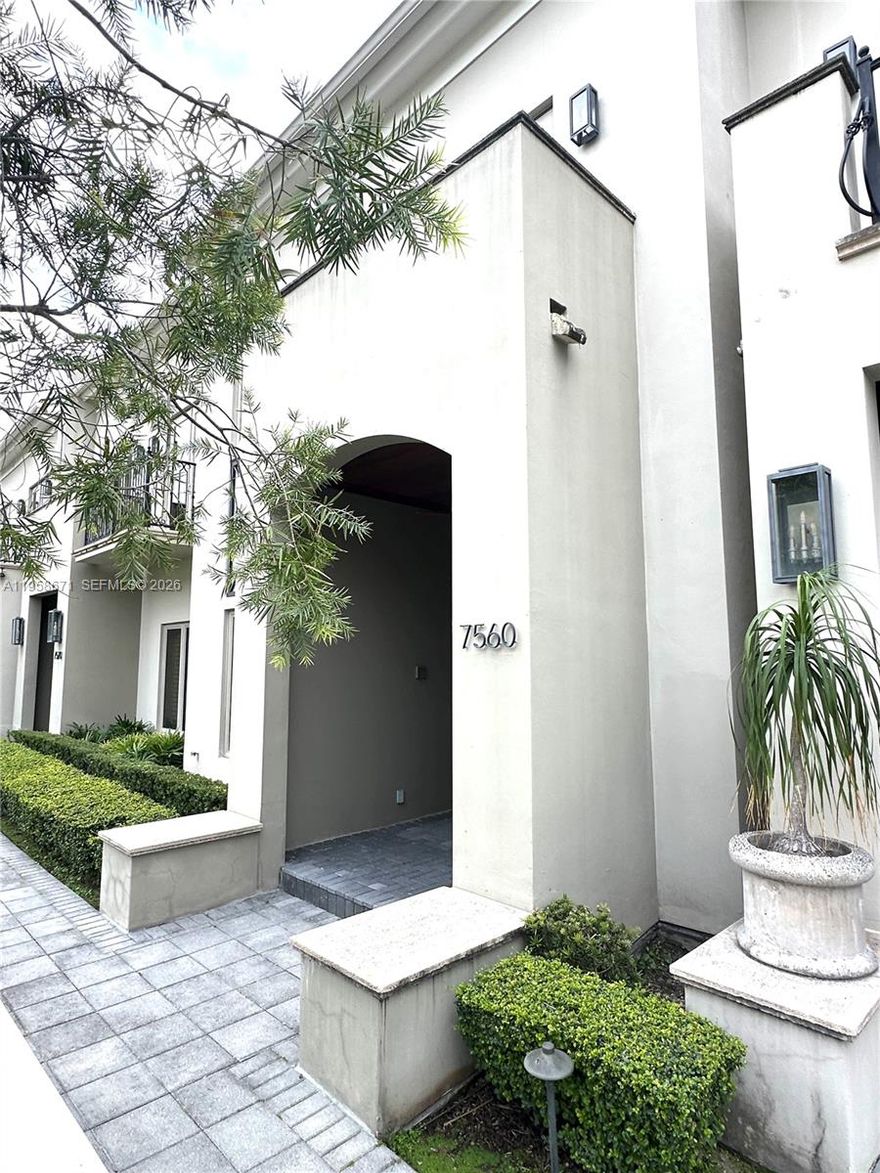 Elegant and desirable three-story residence at gated Townhomes at Oak Lane, ideally located in the heart of South Miami in High Pines. It combines luxury and convenience, featuring a private elevator, marble and wood floors, and impact windows. The open living area centers around a stylish wet bar, with ice maker, beer tap and wine cooler—perfect for entertaining—and a modern kitchen outfitted with gas stove, Wolf and Sub-Zero appliances. The family room opens to an inviting patio with an outdoor kitchen, cocktail pool with relaxing waterfall. Covered private and secure parking for four vehicles, abundant storage, laundry, and a full-house generator add everyday comfort. The large  primary suite includes a sitting area, large closets, and an expansive private balcony retreat. Extra space with a full bath can be an office, gym or guest bedroom.  Walk to South Miami’s favorite restaurants, shops, and the University of Miami; just minutes from Coral Gables, Coconut Grove, and Brickell. Refined urban living at its best near top public and private schools. Easy to show.