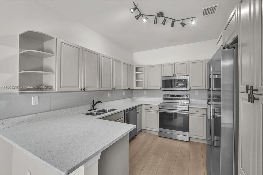 Coastal living just minutes from the beach! Spacious 3-bedroom, 2.5-bath townhome located in the highly desirable, guard-gated community West Lake Village. The open layout features a bright living and dining area, a beautifully updated kitchen with all new appliances and breakfast nook. Upstairs offers a private primary suite with walk-in closet, updated bathroom along with two additional bedrooms. Property has brand new floors and it was  just freshly painted.  Hurricane shutters and new roof.  West Lake Village provides resort-style amenities: 24-hour security, heated pool, jacuzzi, tennis courts, clubhouse, gym, playground, and on-site management. A move-in ready home in an unbeatable East Hollywood location. A perfect place to call it Home. Owner financing available.