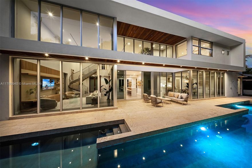 Stunning, contemporary, high-tech South Grove home on coveted Bay Homes DR 20 ft above sea level on lush, gated double lot. Fully solar-powered via state-of-the-art energy grid. Exquisite design; prestige finishes; sunlit, flowing interiors; double-height & volume ceilings; porcelain flrs downstairs, plank upstairs; window walls showcase tropical panoramas. Statement foyer sets modern luxury stage for social & dining spaces. Gas-fired chef’s kitchen. Elevator; en suite bdrms, flr 2 family rm. Lavish primary suite w/private terrace outfitted w/soaking tub. Idyllic SoFla living anchored by heated 60-ft saltwater lap pool. 2-car covered parking. Lifestyle: Priceless walkability, bay access; nearby parks, restaurants & shops. A sophisticated South Grove sanctuary that’s simply sublime.