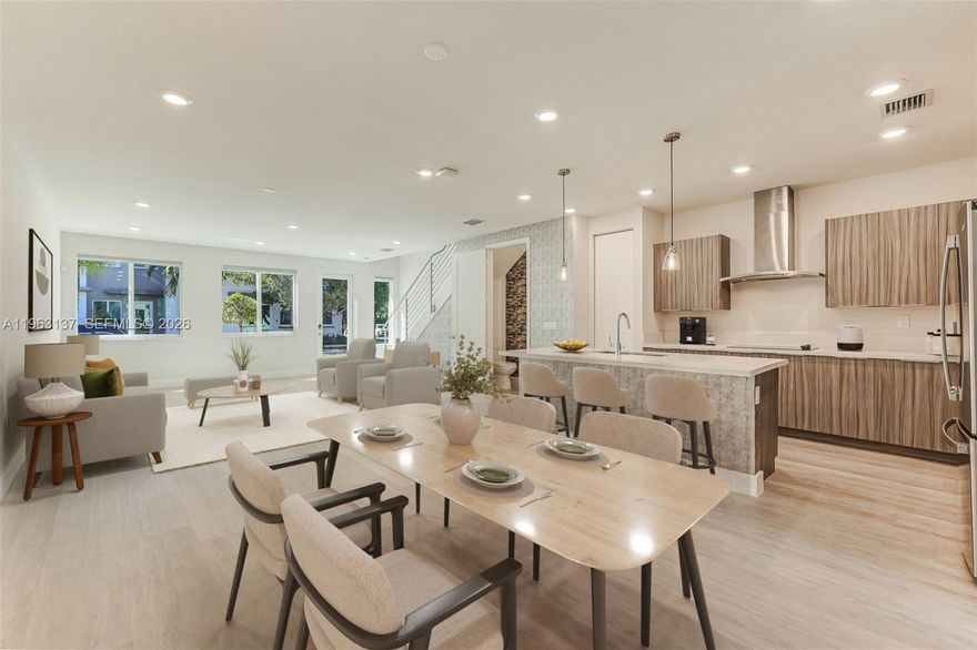 Enjoy modern living with tranquil lake views in this upgraded 3-bedroom, 2.5-bath townhouse located in the desirable Landmark at Doral. Features include laminate wood flooring, impact windows and doors, custom window and wall treatments, and an energy-efficient design. The contemporary kitchen offers quartz countertops, recessed lighting, and stylish finishes, opening to a spacious living area and private back patio with low-maintenance turf and peaceful water views. Additional highlights include a 1-car covered garage, extended 3-car driveway, EV charging port, Vivint alarm system, and full smart home integration. Conveniently located near the clubhouse, fitness center, and community amenities. Move-in ready and designed for modern comfort.