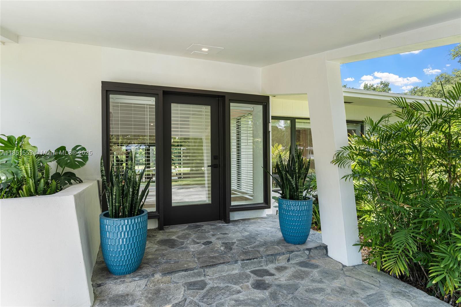 Substantially renovated and set on a lush 39,204 SF lot along a picturesque tree-lined street in Pinecrest, this 6-bedroom, 6.5-bathroom residence offers nearly 7,000 SF. The expansive layout flows through large open areas with views of the beautifully landscaped backyard and sparkling screened pool. Main living areas feature large-format Spanish gray tile, while the bedrooms offer engineered oak flooring. The kitchen showcases timeless wood cabinetry, sleek black granite countertops, and ample storage. A luxurious 1,600 SF primary suite includes custom vanities, beautifully finished bathrooms, and spacious closets. Impact windows and sliding doors provide seamless indoor-outdoor flow. A large pool, covered terrace, and 3-car garage complete this exceptional home.