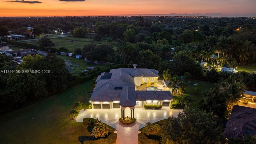 Most homes offer space—this one delivers scale, lifestyle, and presence at a completely different level. Tucked away on a quiet cul-de-sac in Davie, this impressive estate spans over 7,000 sq ft with 9 bedrooms and 7 bathrooms, designed for those who want room to live, entertain, and truly spread out.

From the moment you enter, soaring ceilings and expansive open living areas create a grand first impression. Natural light pours through the home, highlighting the scale of each space. The layout is thoughtfully designed for both everyday living and large gatherings, with a seamless flow between the chef’s kitchen, multiple living areas, and entertainment spaces.

This home is built for lifestyle. Enjoy a private cinema, game room, and dedicated gym, creating a full in-home experience without ever needing to leave. Every room feels oversized, every space intentional—perfect for large families, multi-generational living, or hosting at a high level.

Step outside and the property truly separates itself. The backyard is a resort-style retreat on a massive lot, featuring a heated pool, spa, hammocks, and a full BBQ area. The scale of the outdoor space is exceptional—offering privacy, openness, and the kind of setting that feels like a private resort. Whether entertaining guests or enjoying quiet nights under the stars, this is where the home truly shines.