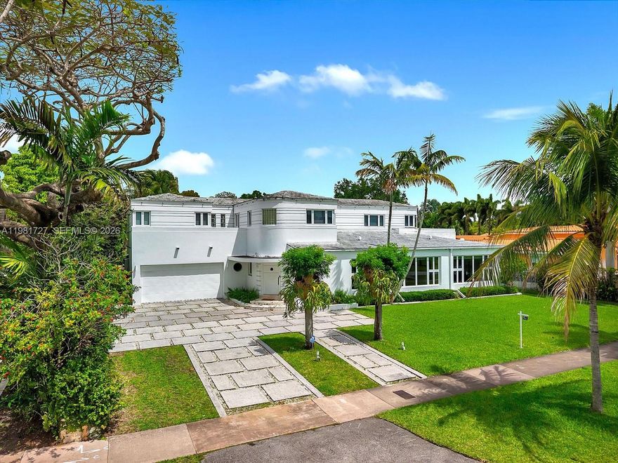 Welcome to a rare 1937 Art Deco Streamline Moderne masterpiece in the prestigious City of Coral Gables, perfectly positioned across from the Granada Golf Course. Recognized on the Coral Gables Registry of Historic Places, this architecturally significant residence was designed by William H. Merriam—celebrated for his Moderne and Mediterranean works—and beautifully blends historic pedigree with timeless Coral Gables charm.
A gracious round foyer with original terrazzo floors introduces the home and leads to the formal living room with a wood-burning fireplace and an inviting library, both showcasing the craftsmanship of the era. The first level offers 2 bedrooms and 2 full baths plus a guest bath, along with formal living and dining rooms, a library, family room, and a billiard room, providing exceptional spaces for both everyday living and entertaining. The original curved staircase, a hallmark of Streamline Moderne design, guides you to the second floor, where you’ll find 4 additional bedrooms and 3 bathrooms, including the main suite, as well as a charming children’s den. Expanded over the years yet rich with preserved architectural details, this home is a rare opportunity to own a piece of Coral Gables history in an iconic setting.