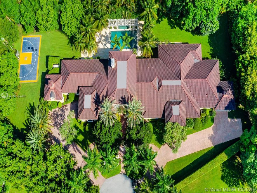 Enjoy family living in this GATED ONE STORY home ideally located on a peaceful cul-de-sac in the prime location of North Pinecrest featuring 7 beds,7.5 baths & 12,377SF Total.This quality home lies on a lush 55,756SF Lot w/stunning outdoor spaces ideal for entertaining,large pool,professionally lit basketball court,bbq & plenty of yard space.Within this single story home you will find the ideal layout,offering expansive state of the art kitchen w/viking appliances, espresso maker, large pantry & wine cellar.Formal living,dinning room,family room w/a full bar,office & gym.Each of the 7 rooms has their own ensuite baths. Impact windows throughout as well as 2 car garages - 4/attached plus driveway parking space. 60KW generator. Walking distance from Miami’s best private and public schools.